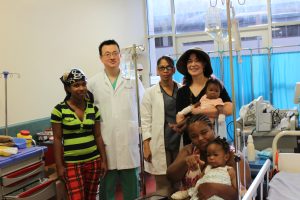 photo of nadia, two other doctors and a family